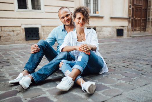 guy and a girl happily walk in the morning on the empty streets of old Europe