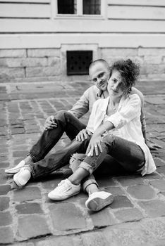 guy and a girl happily walk in the morning on the empty streets of old Europe