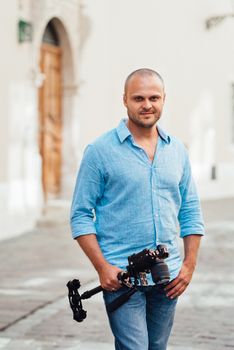 young guy, photographer walking in the old streets poland of europe