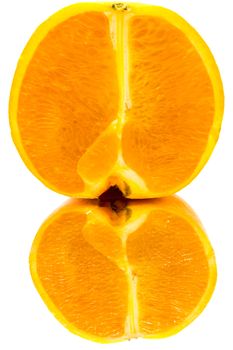 Close up on an orange half with a reflection on a white background