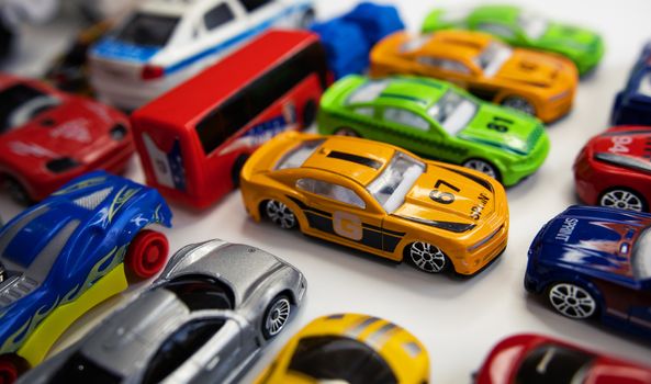 Toy cars of different colors arranged on a white background.