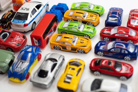 Toy cars of different colors arranged on a white background.