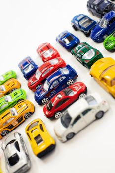 Toy cars of different colors arranged on a white background.