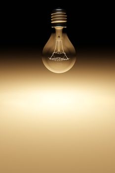 The filament is glowing inside vintage light bulb in dark black background without electrical wire. Concept of using brain to think and analysis to find ideas for solving business problems. 3D render.