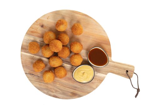 Dutch traditional snack bitterbal on a serving board, isolated