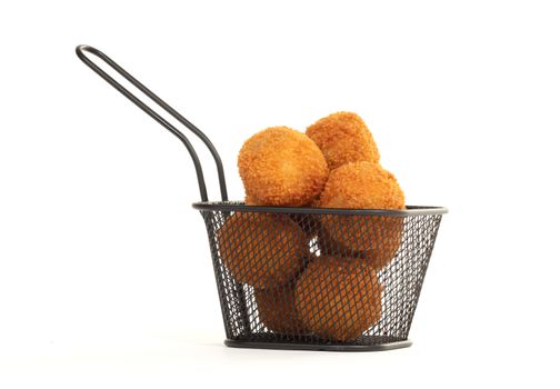 Dutch traditional snack bitterbal in a small basket, isolated