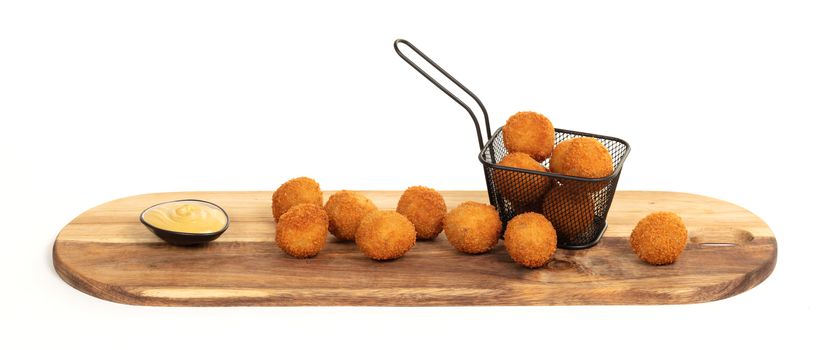 Dutch traditional snack bitterbal on a serving board, isolated