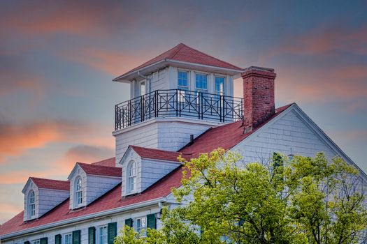 Cliassic white home with red roof, dormers and widows walk