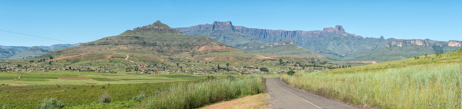 A panoramic view of the Amphitheatre in the Drakensberg with Bonjaneni township in the front. Dooley Hills are visible to the right