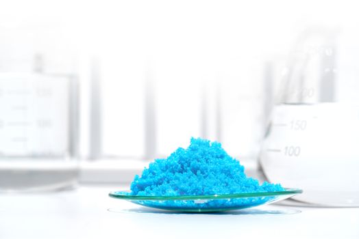 Close up inorganic chemical on white laboratory table. Copper(II) sulfate,  alcohol. Chemical ingredient for Cosmetics & Toiletries product.