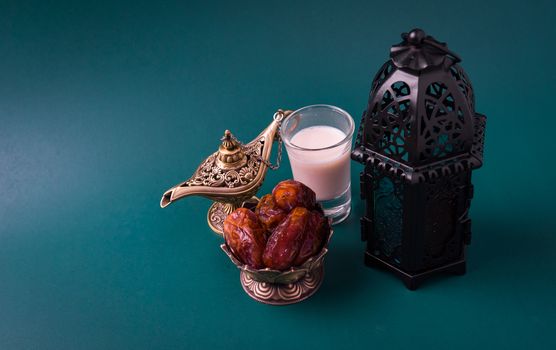 Ramadan Kareem fasting Food Concept, Bronze plate dates, milk, and lantern Aladdin lamp decoration, eid Arabian Muslim religious festival on a dark green background with copy space for text