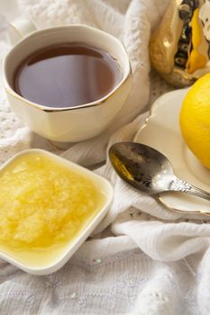 Lemon and green tea in white cup, fresh healthy detox tea, vertical image