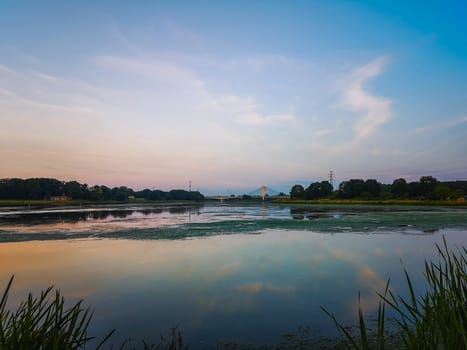 Landscape with colorful sky reflecting in river