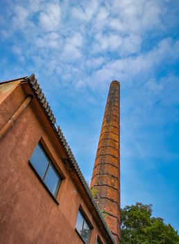 Bottom look up to brick chimney at sunny day in Wroclaw City