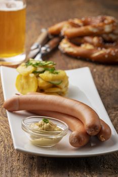 closeup of frankfurter sausages on rustic wood