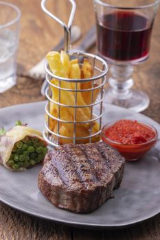 closeup of grilled steak with french fries