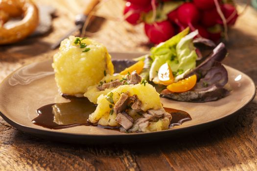 stuffed potato dumplings with salad on wood