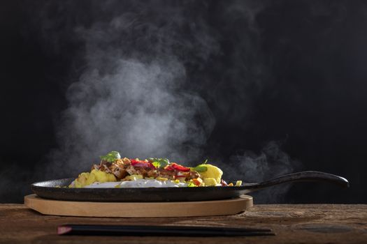 steaming hot sizzler on wood