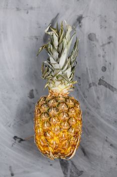 Ripe Whole Pineapple on Grey Concrete Background