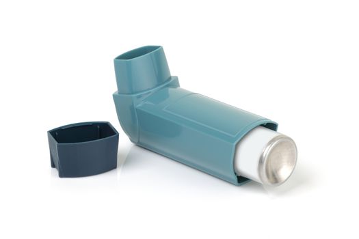 An asthma inhaler on a white background with light reflection