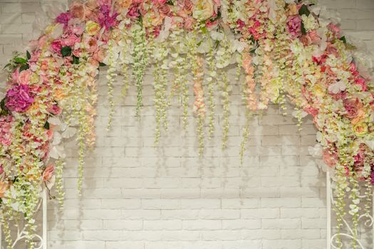Wedding arch with flowers for the wedding ceremony. Wedding flower background