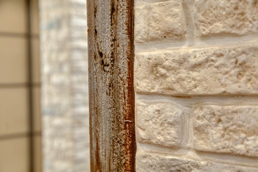 A fragment of the wall lined with white brick. Brick background.