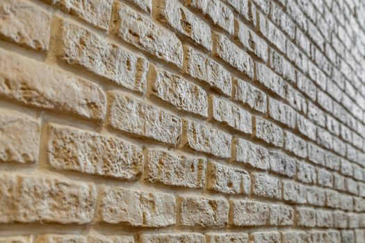 A fragment of the wall lined with white brick. Brick background.