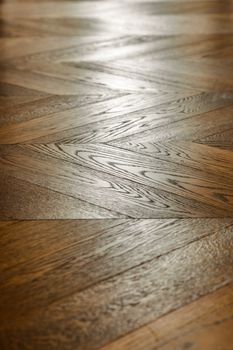 Fragment of brown wooden parquet floor. Wooden background.