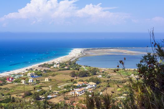 Ai Yiannis, Mili is a long sandy beach on the island of Lefkada, Greece. Preferred by wind and kite surfers. It covers a stretch of 4.5 km and the waters are turquoise coloured.