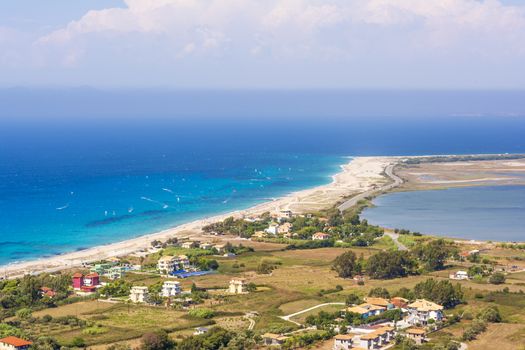 Ai Yiannis, Mili is a long sandy beach on the island of Lefkada, Greece. Preferred by wind and kite surfers. It covers a stretch of 4.5 km and the waters are turquoise coloured.