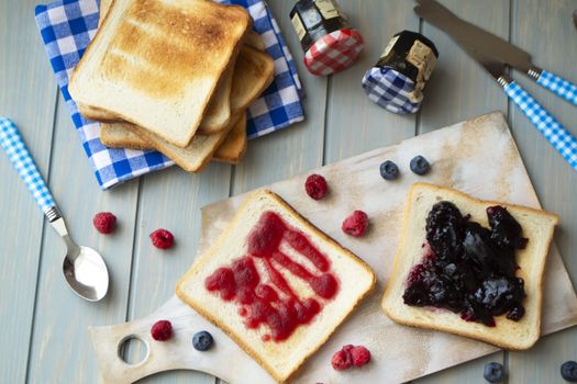 Jam on toasts on wooden background, vintage, flat lay