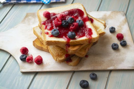 French toast with jam and berries, rustic and vintage
