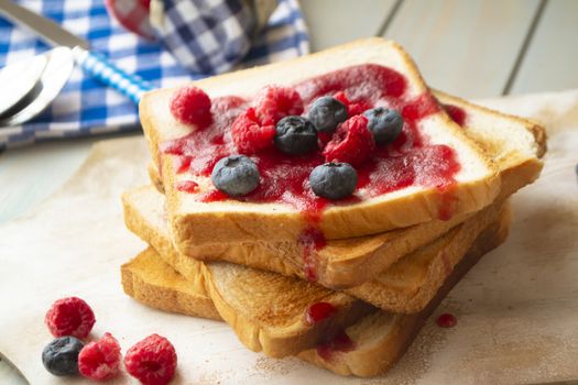 French toasts with fresh summer berries and maple syrup