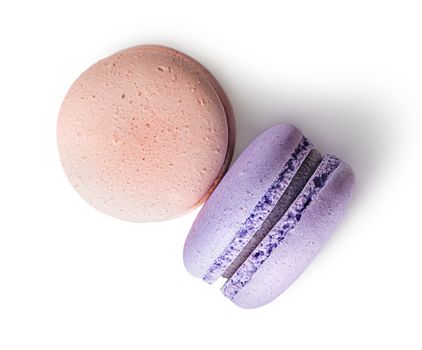 Two macaroon beige purple top view on white background