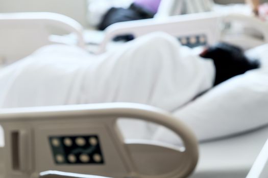 Close up of Patient bed with Elderly patients in hospital