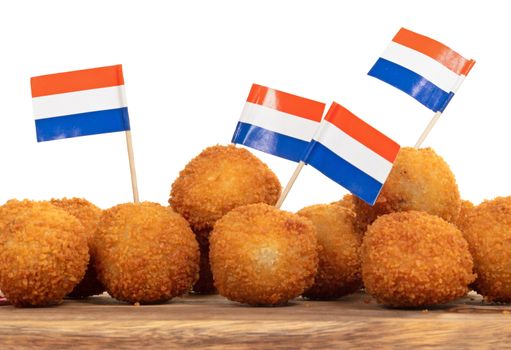 Dutch traditional snack bitterbal on a serving board, dutch flag, isolated