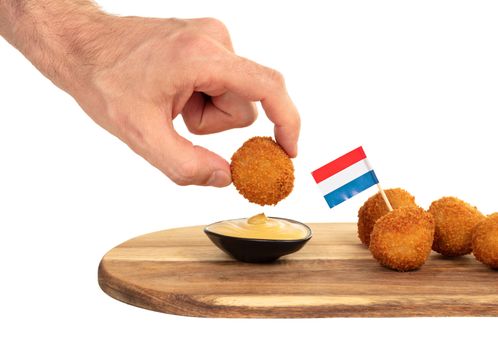 Dutch traditional snack bitterbal in a hand, isolated