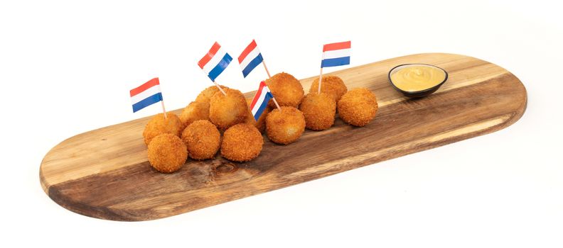 Dutch traditional snack bitterbal on a serving board, dutch flag, isolated