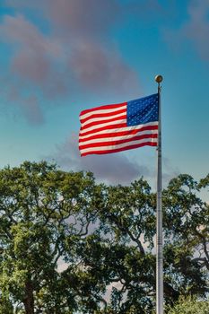 American Flag blowing in the wind at the top of a flagpole