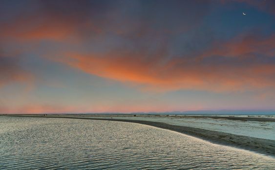 A shallow tidal pool at sunset or sunrise