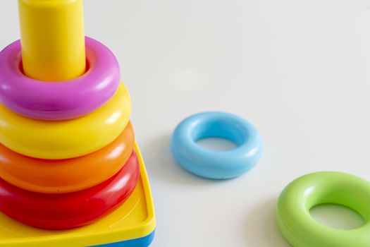 Colorful plastic rings stacked in a tower. Toy for newborns.