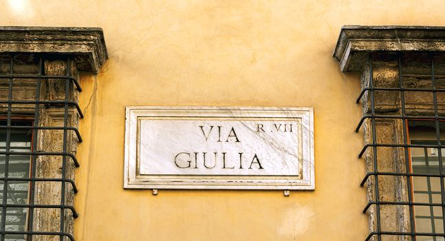 The indication of the Via Giulia address in an old marble sign in Rome.