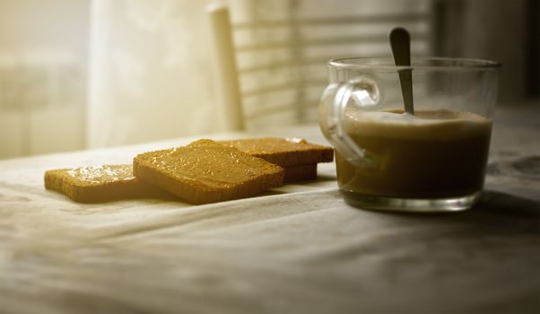 morning breakfast with frothy cappuccino and toast with jam. Interior shot.