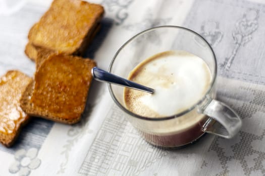 morning breakfast with frothy cappuccino and toast with jam. Food and coffee. Breakfast at the hotel