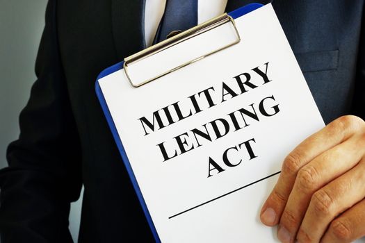 Man is holding Military Lending Act MLA.