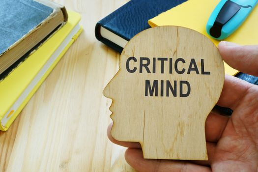 Critical mind sign on the wooden haed shape.