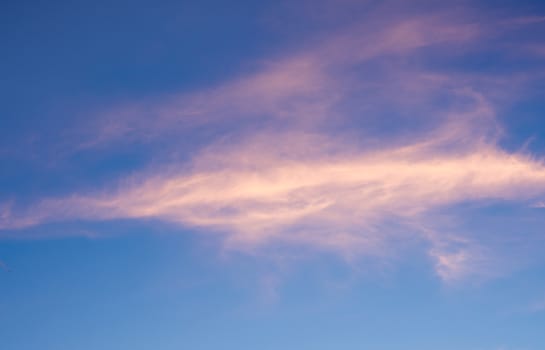 White fluffy clouds in the blue sky with morning light from the sunrise