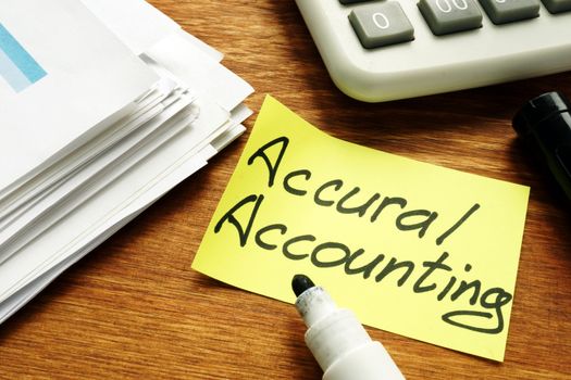 Accrual Accounting concept. Business report and calculator.