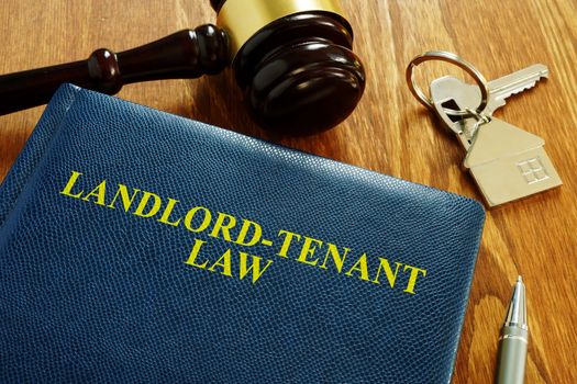 Landlord Tenant Law book and key from home.