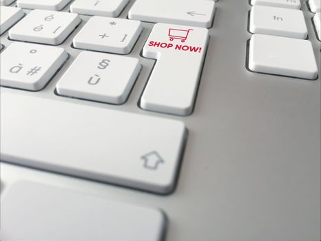 Close up of a computer keyboard with a button with a red cart icon. Shopping online keyboard shortcut